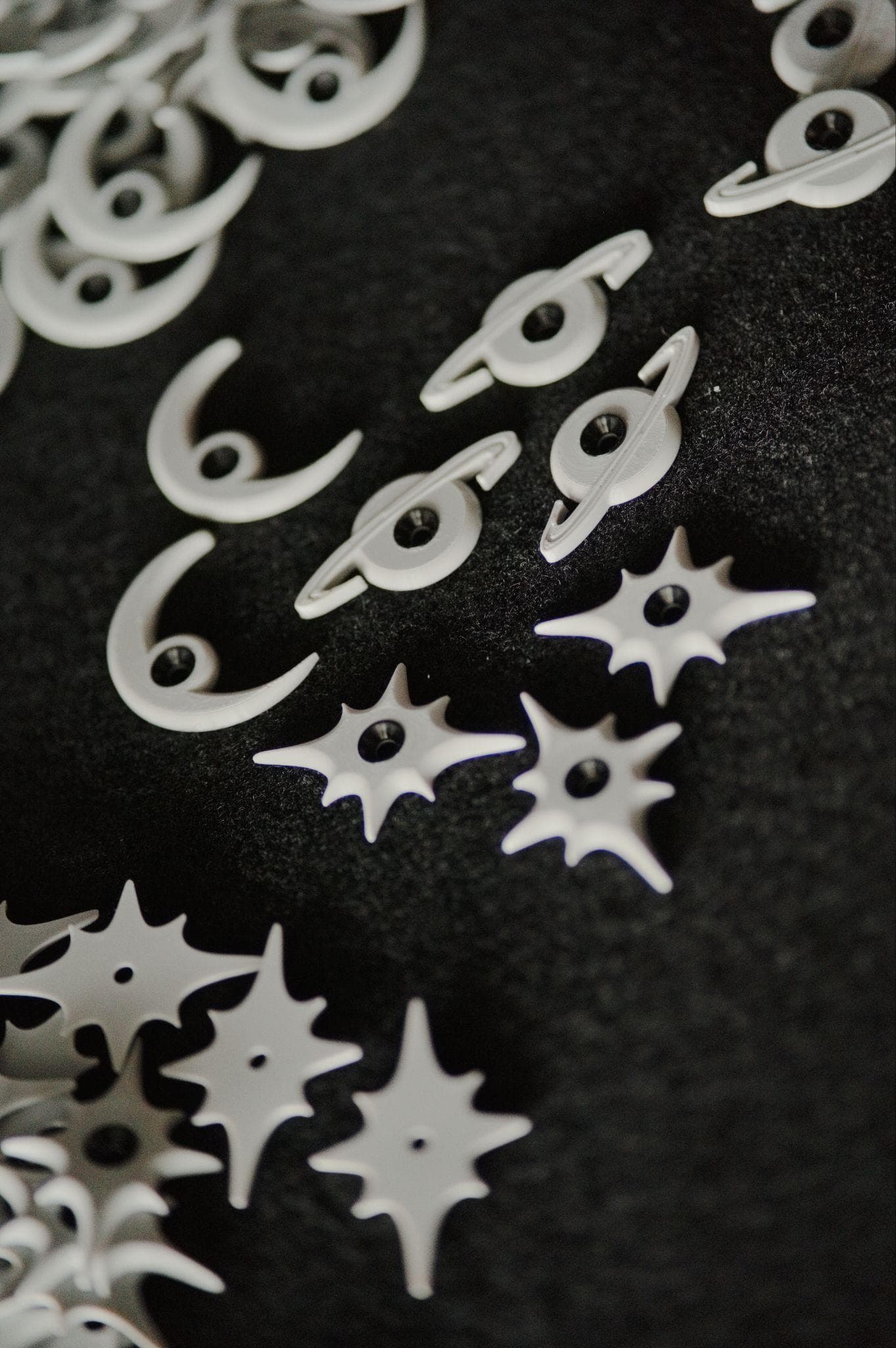 Crescent moon and star route tags grouped together on black felt